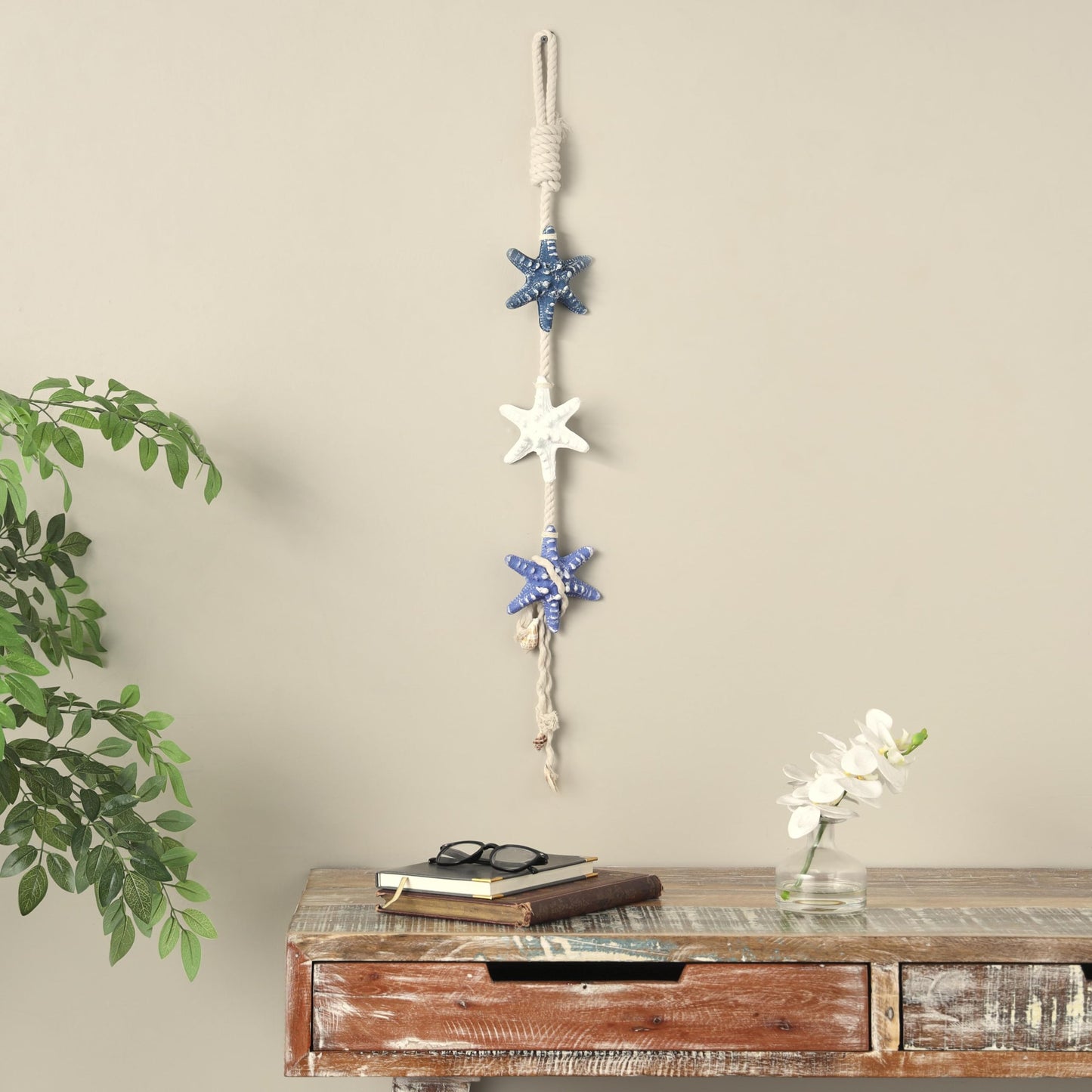 Deco 79 Resin Starfish Handmade Home Wall Decor Layered Wall Sculpture with White Hanging Rope and Seashell Accents, Wall Art 5" x 2" x 34", Cream